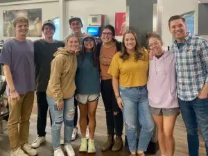 Group of co-ed college students pose together for a picture