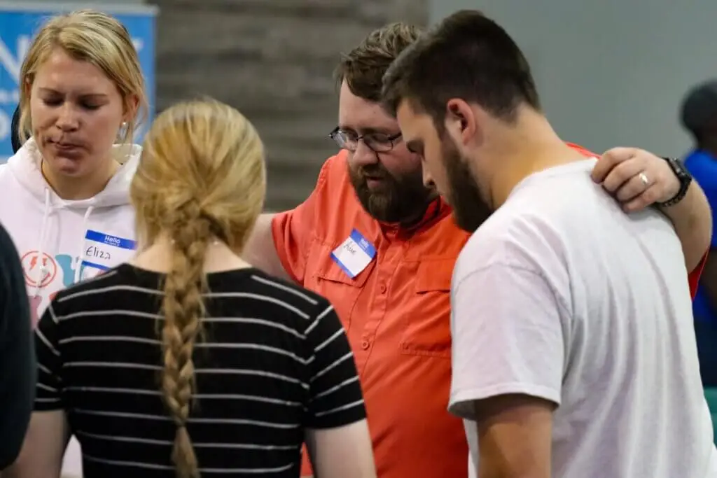 Young men and women gathered together while prayer walking