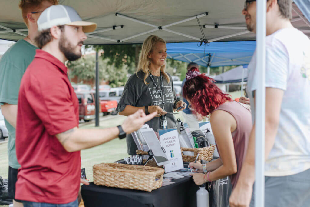 People hand out information about churches on college campus