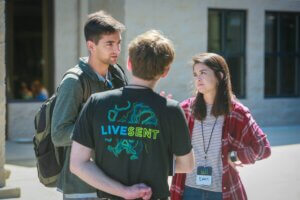 Two guys and a girl talk together outside of Live Sent missions conference