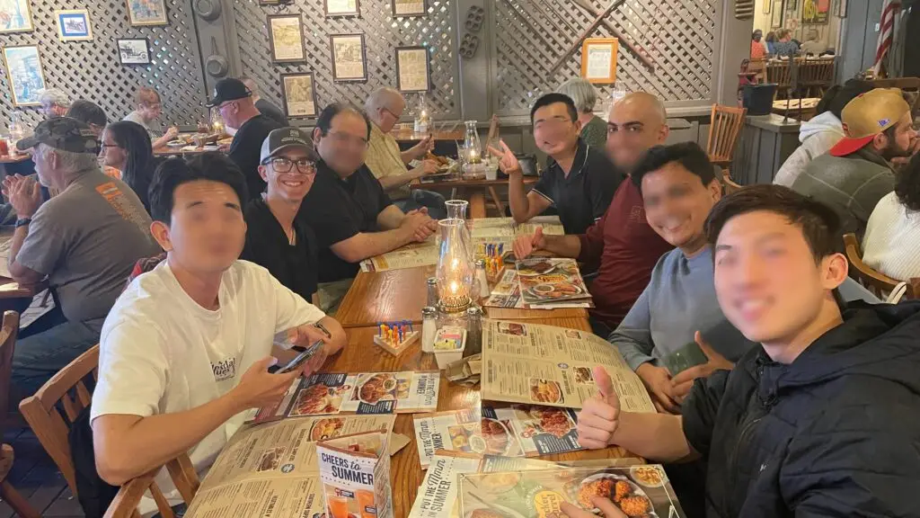 Group of people eating a meal together at a restaurant