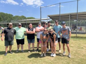 College co-eds standing on a kickball field