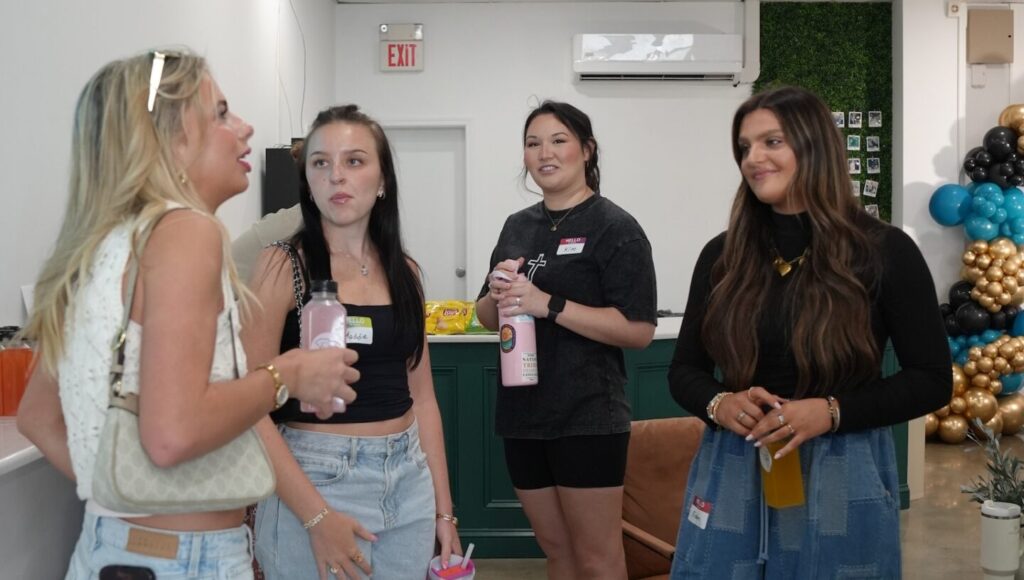 Group of sorority girls standing in a circle talking